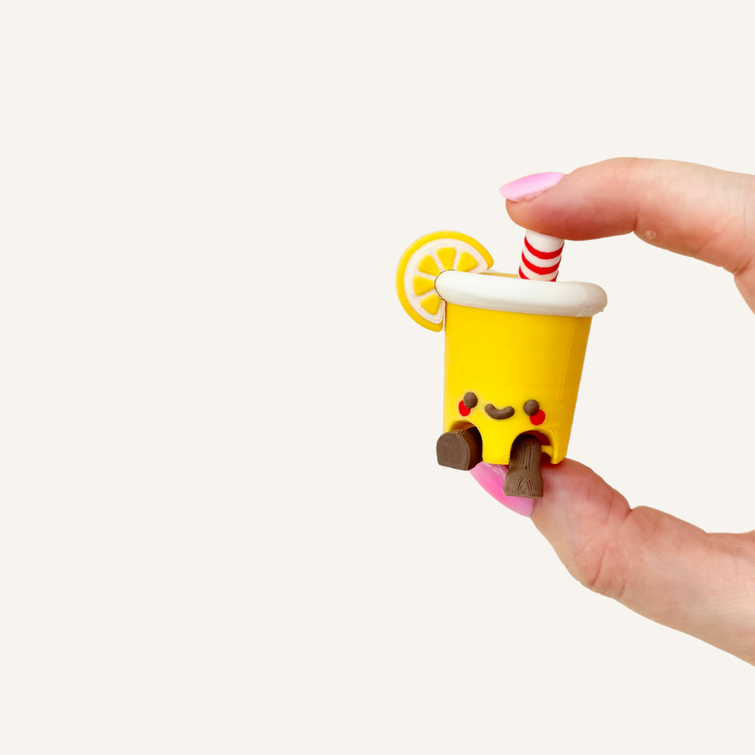 Lemonade cup sensory clicker with pressable feedback, smooth finish and portable fidget use.