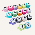 Flexible linked clicker fidget with custom letters, quiet or loud click options and ribbed edges for tracing.