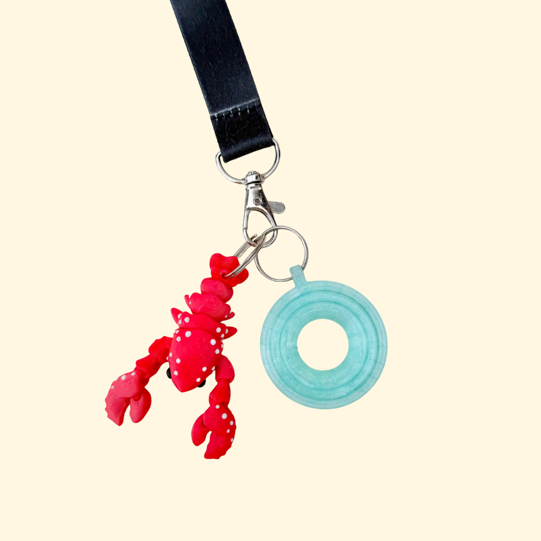 Articulated lobster lanyard add-on with raised bump texture and high movement for sensory stimming.
