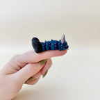 Compact flexible fidget with textured surface designed for discreet pocket use and sensory input.
