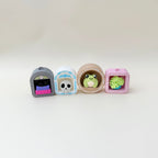 A compact clicker fidget with a framed design and interchangeable icon choices.

