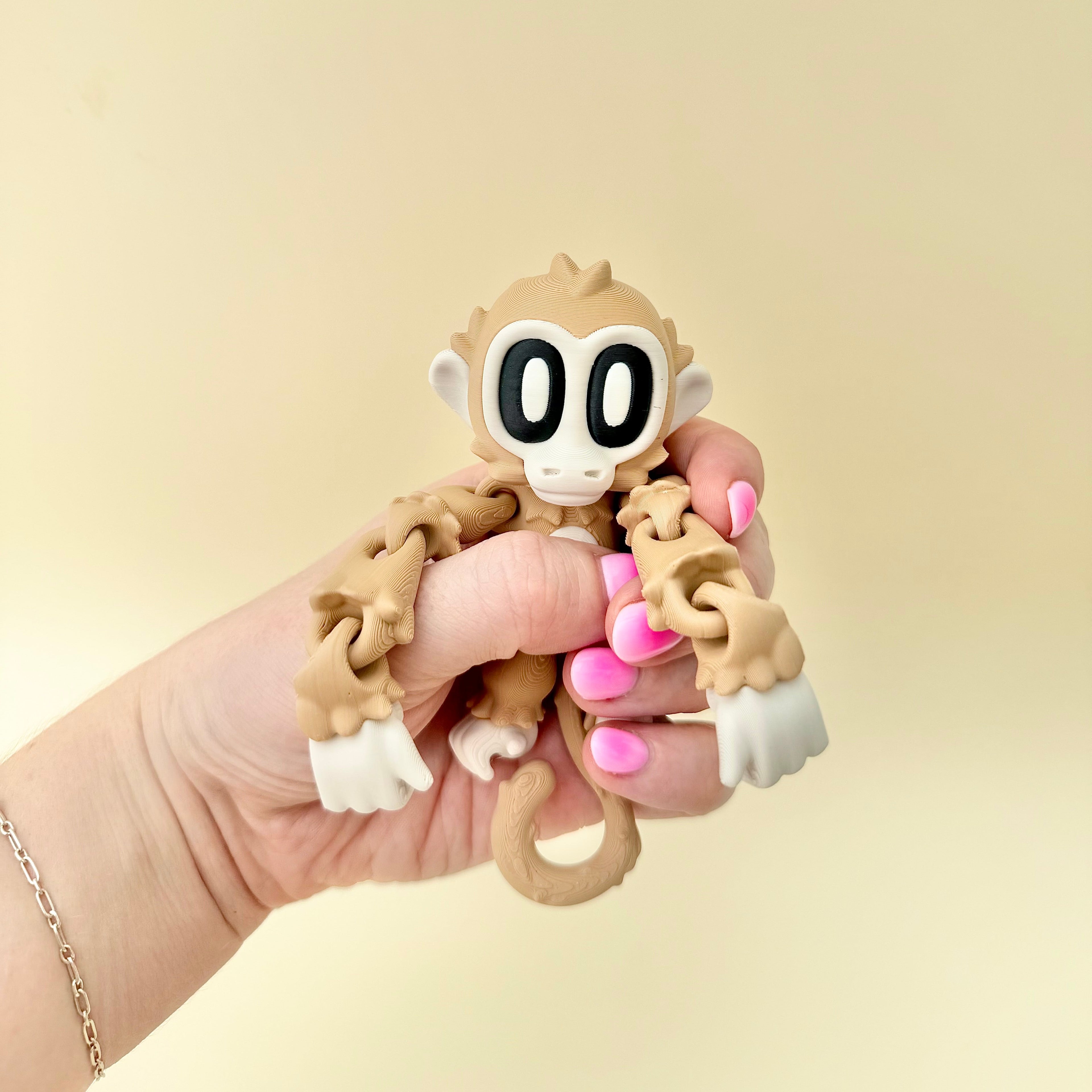 Small flexible monkey fidget for tactile input, repetitive movement, grounding and neurodivergent sensory support.