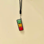 Three-button mood fidget with visual face symbols, tactile click feedback and wrist strap attachment.