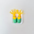 Palm-size corn with a hinged bite that reveals teeth and a tongue for playful stimming.
