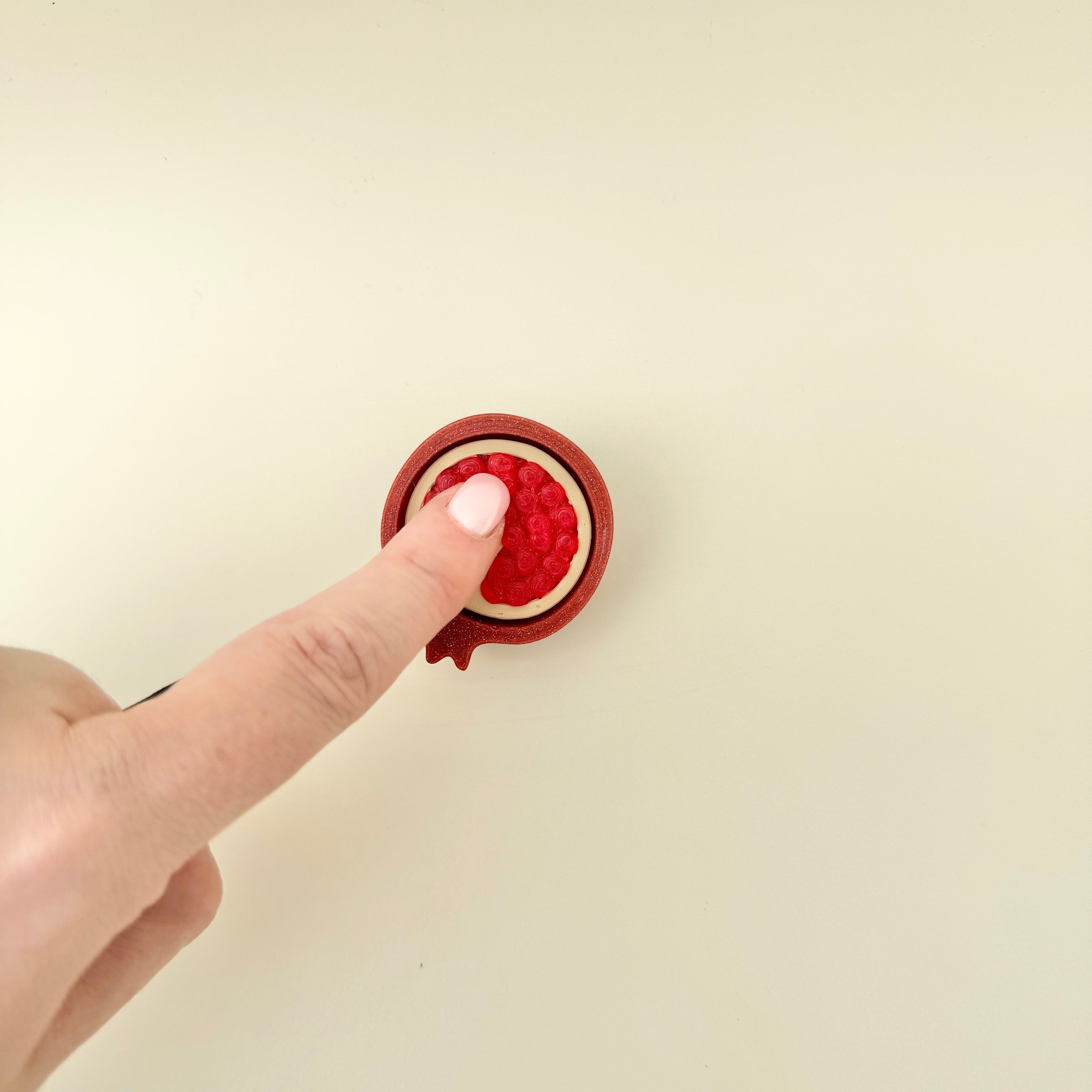Compact tactile and click fidget designed for everyday use, offering both texture and press feedback