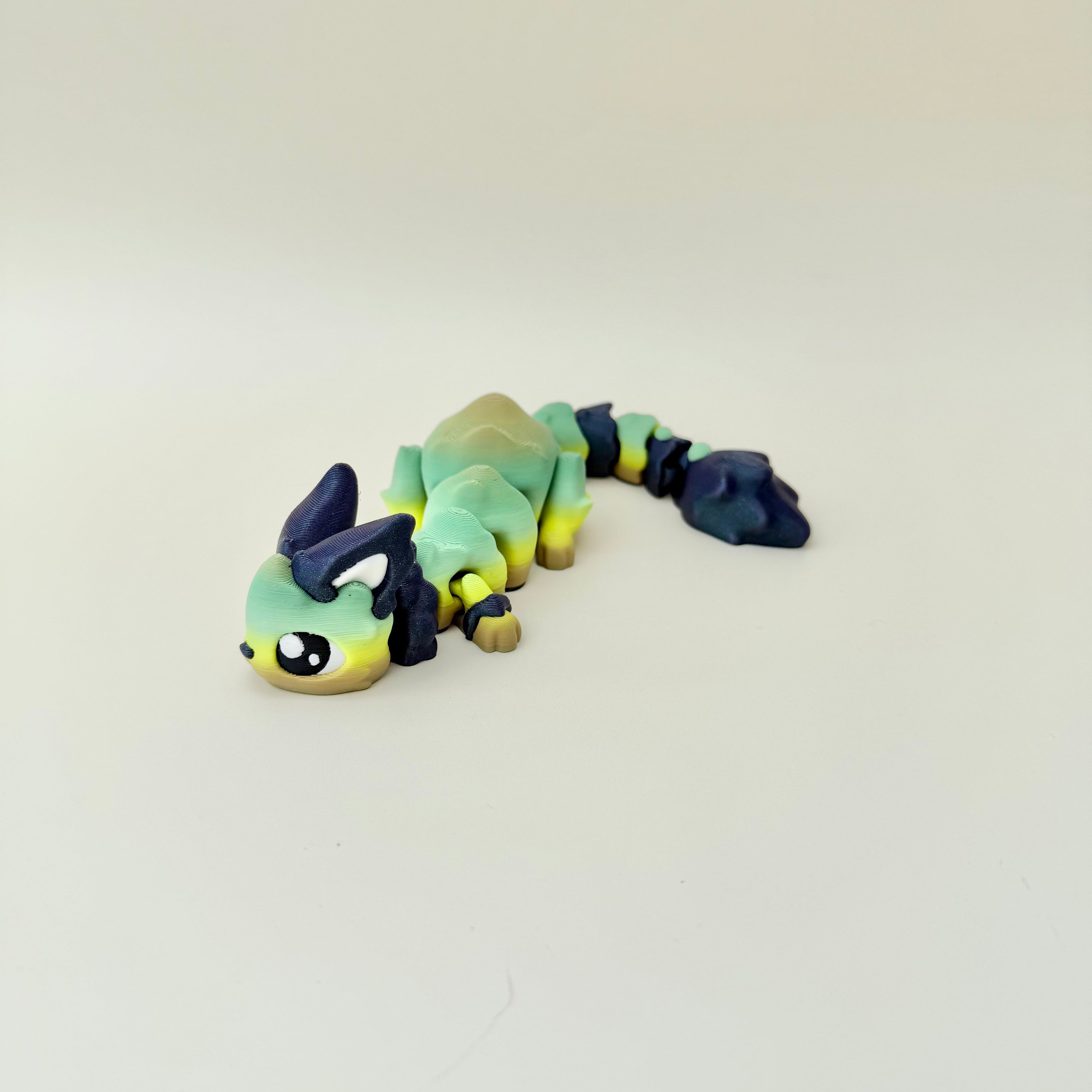 Long articulated creature fidget designed for busy hands, desk play and sensory regulation.
