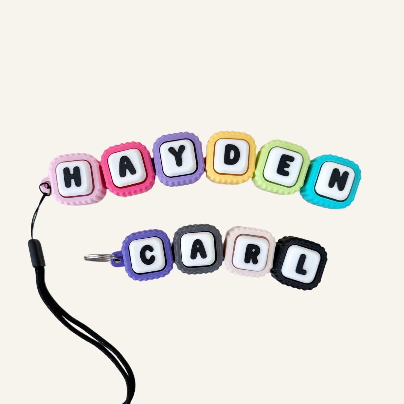 Personalised linked clicker for names, words and initials, with flexible movement and tactile click feedback.