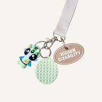 3D printed communication tag with raised text and silver loop for everyday visible support.