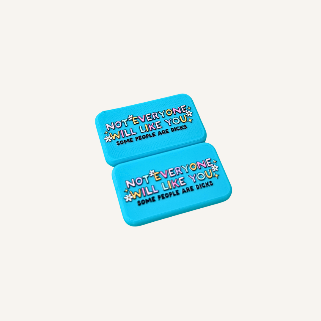 Two tactile blue fidget magnets with colourful raised artwork and magnetic snap together design