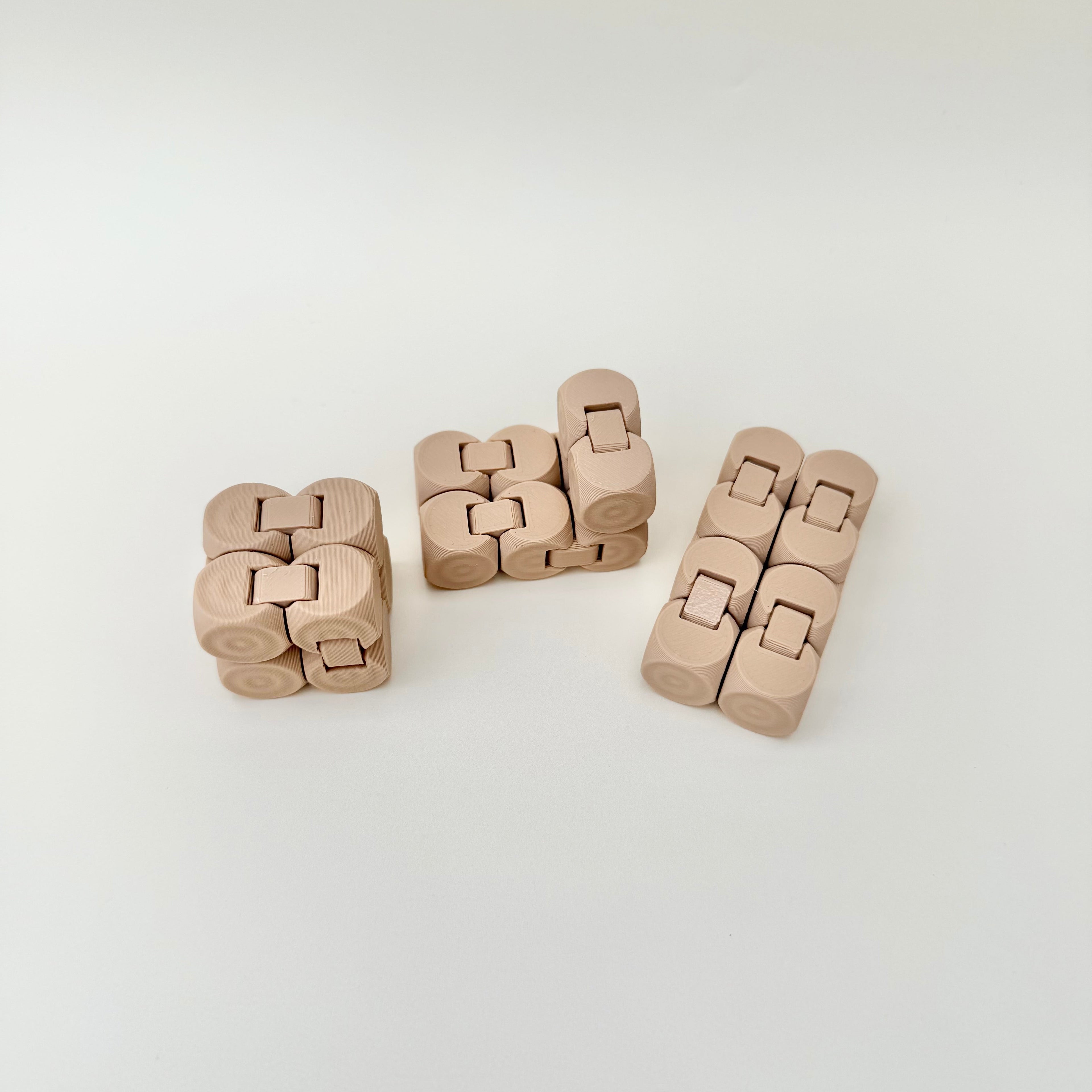 Pocket-sized sensory fidget with raised dot grip and foldable sections for one-handed play.
