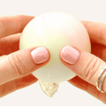 Wax-crackle sensory squish in a protective plastic ball with a soft dough-like feel for squeezing and pressing.