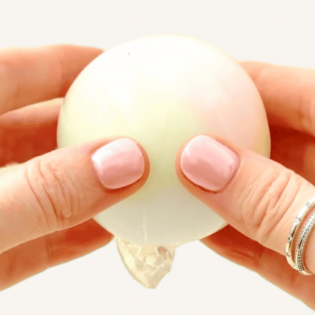 Wax-crackle sensory squish in a protective plastic ball with a soft dough-like feel for squeezing and pressing.