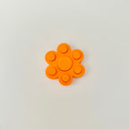 Handheld PopBack fidget spinner designed for smooth spinning and satisfying press feedback in a small size.
