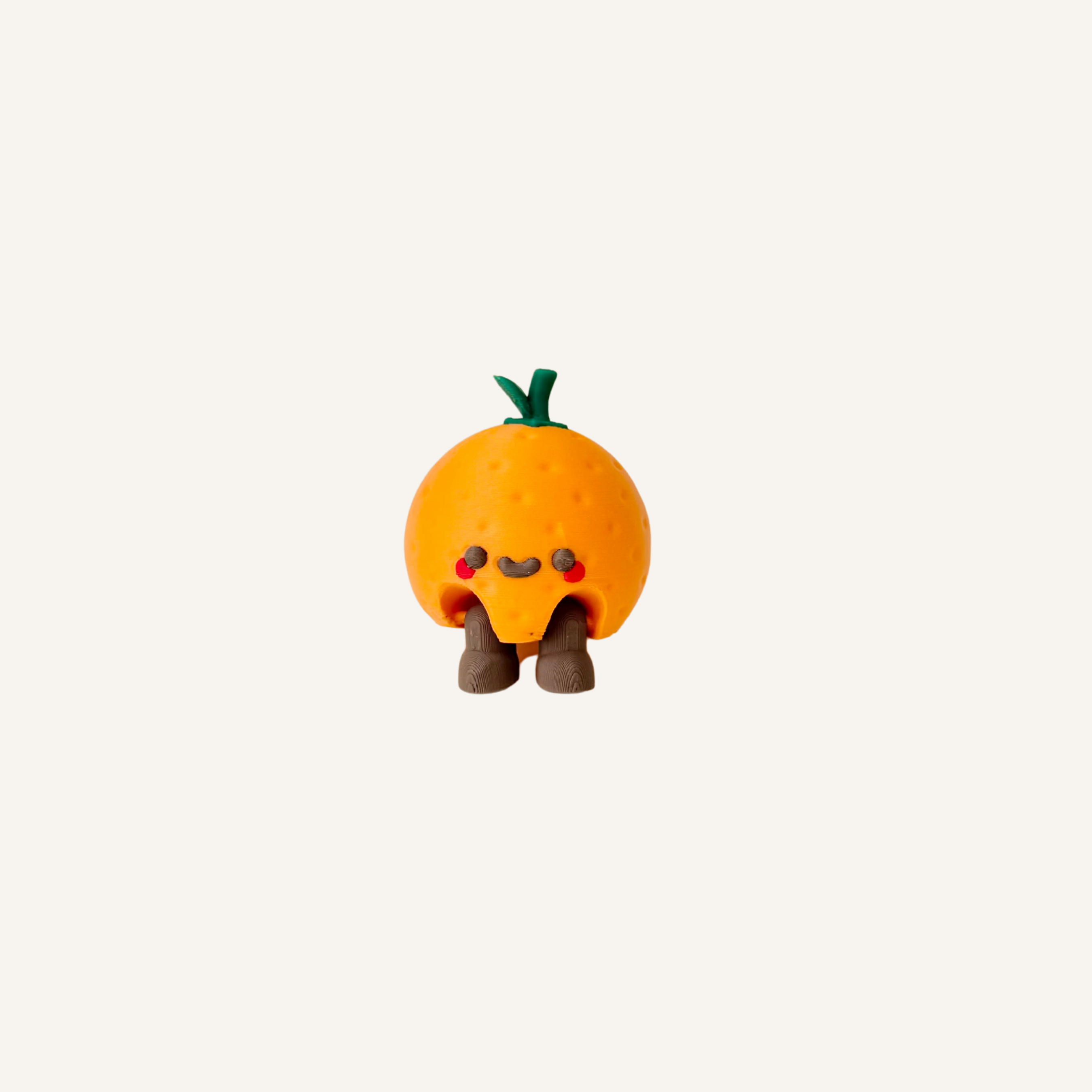 Cute mini orange character with dangling legs designed for desks, shelves and feel-good decor in neuro-friendly spaces
