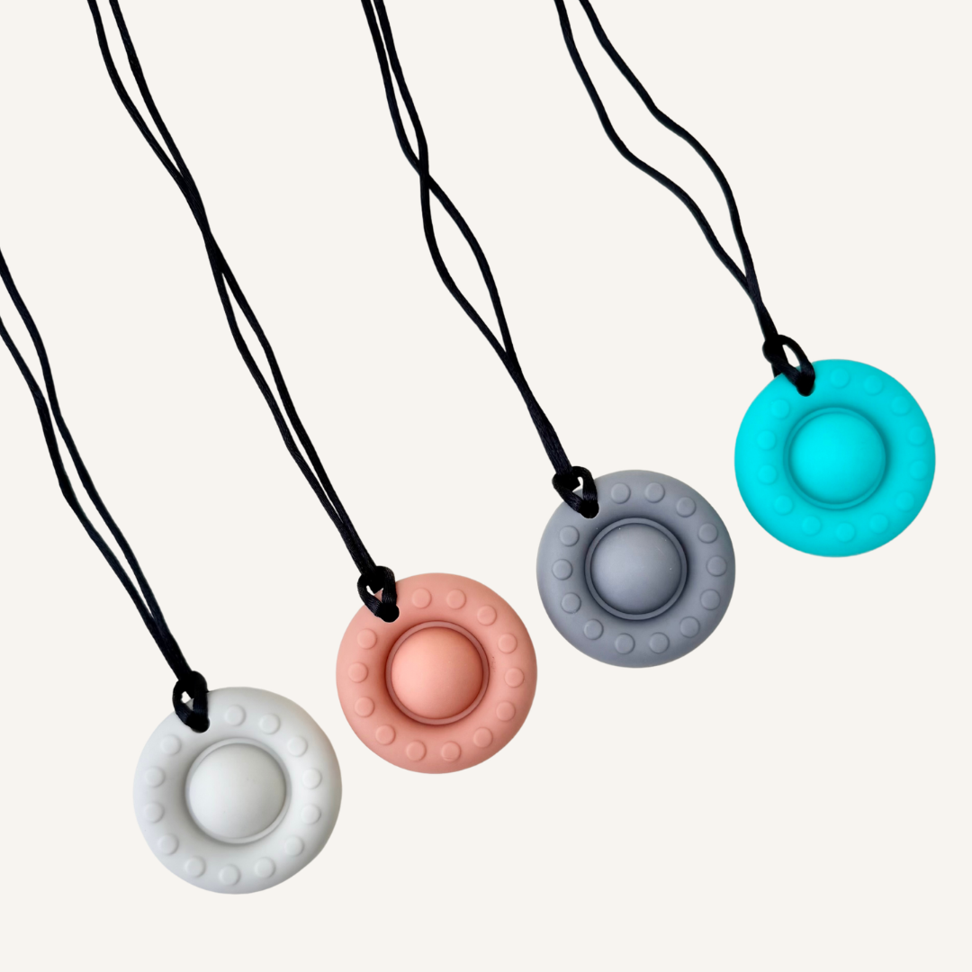 Round silicone chew stim with pop-it style centre for light chewing, oral sensory input and portable sensory support.
