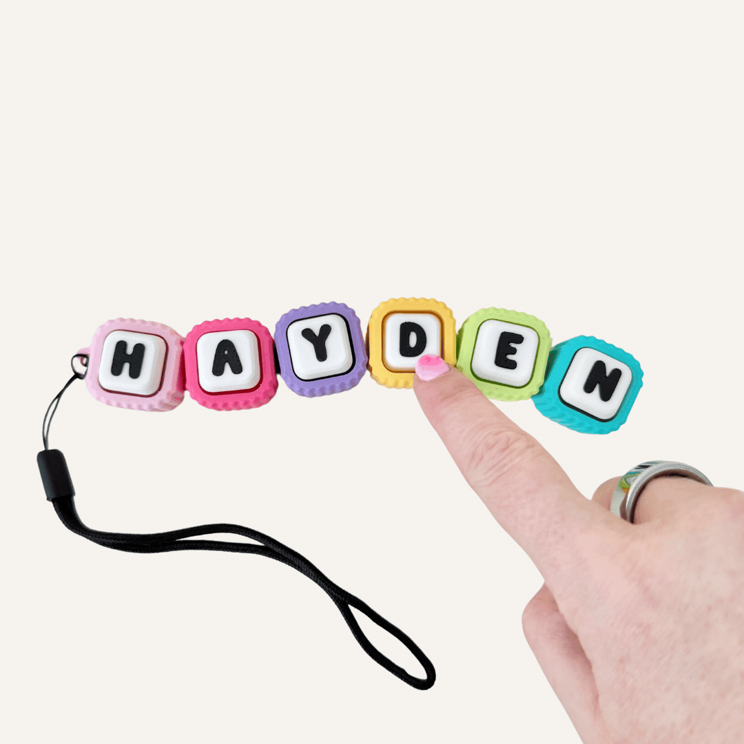 Personalised clicker fidget with individual clicking letters for busy hands, grounding and repetitive sensory input.