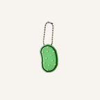 Pickle-shaped sensory clicker with wrist strap for bags, keys and everyday carry.