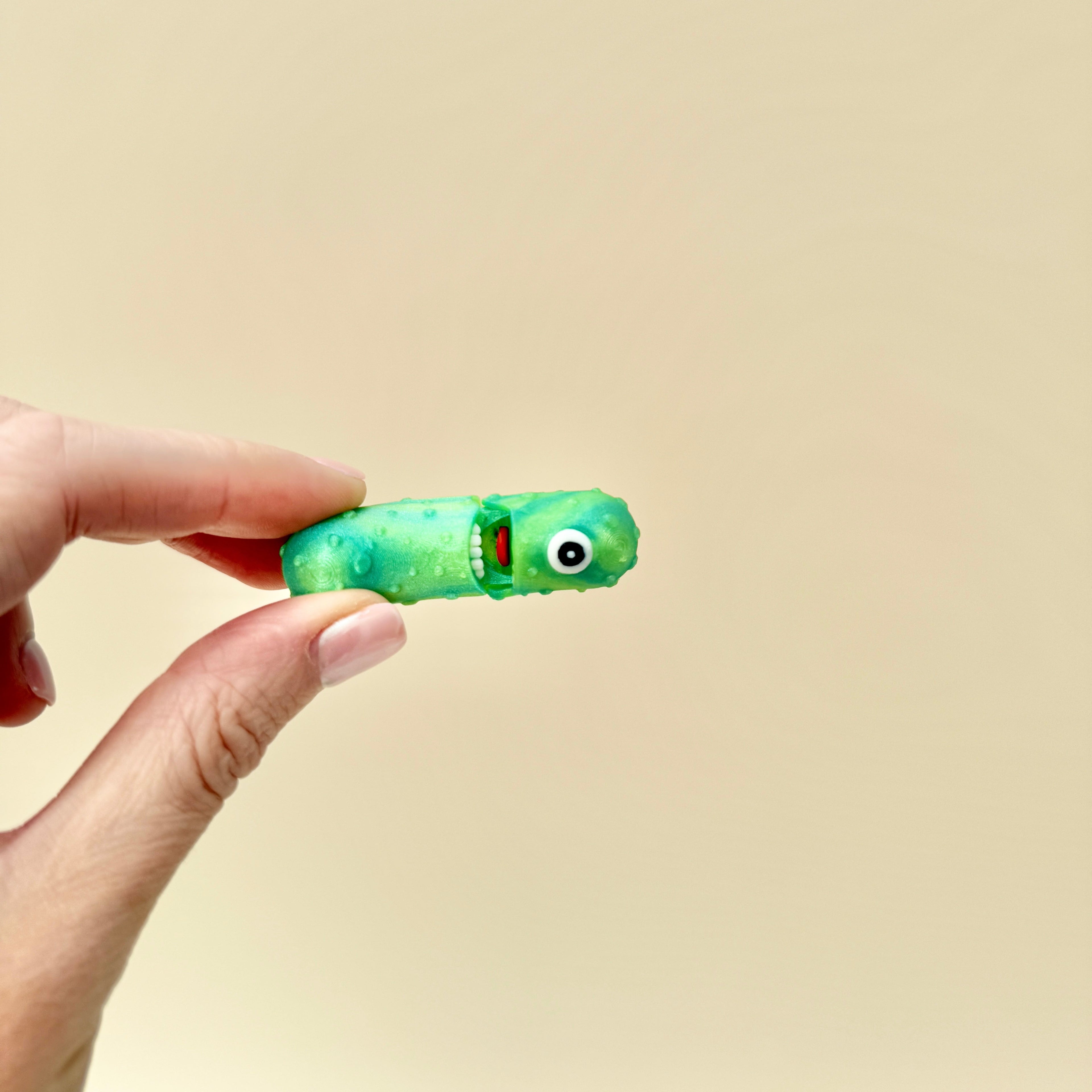A fun and quirky one-eyed pickle fidget toy, ideal for pickle fans and collectors.