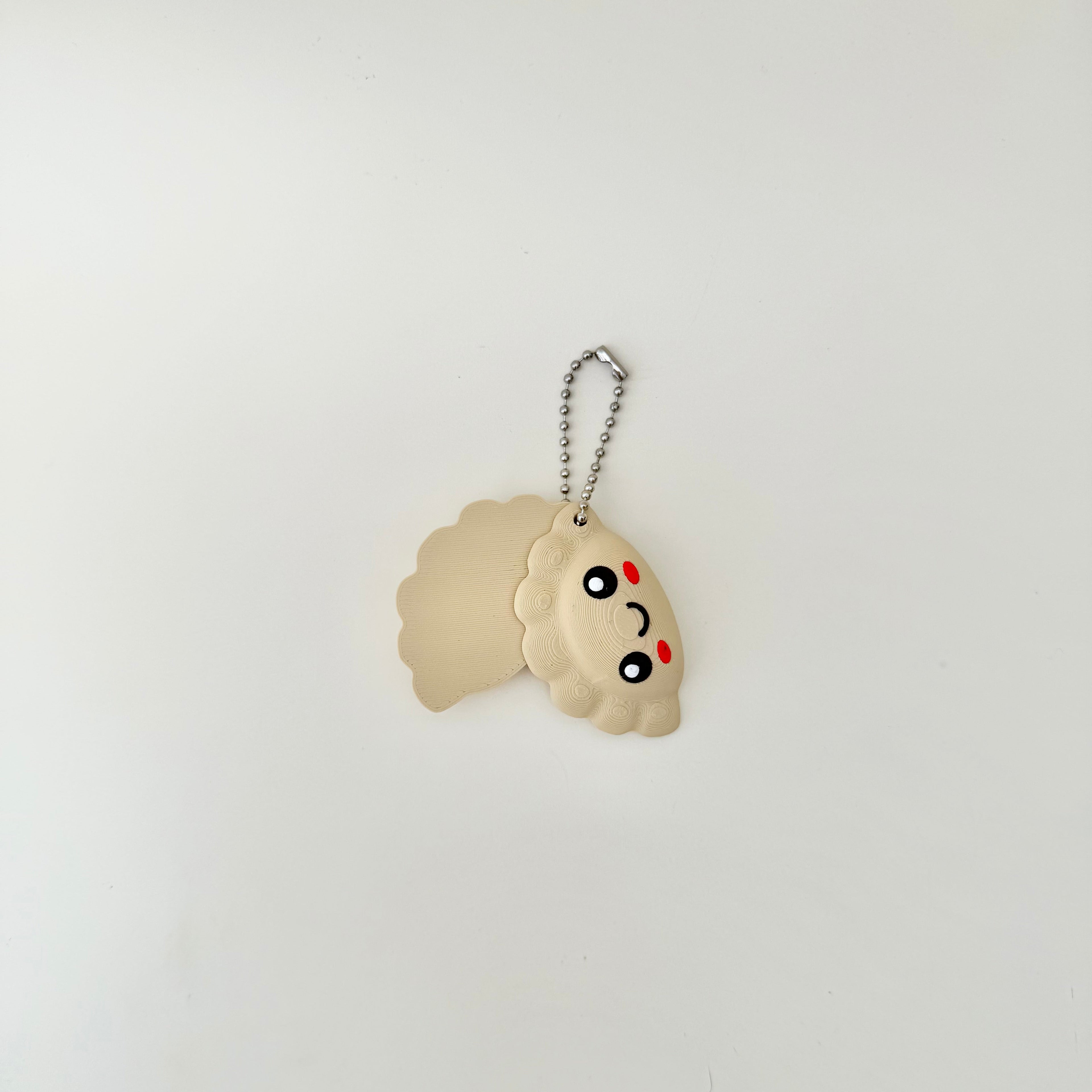 Portable swing magnet sensory fidget shaped like a dumpling with smooth movement and easy low resistance magnetic pull.
