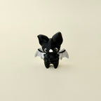 small winged fidget figure designed for grounding and focus breaks; no-click design; tactile textures for thumb tracing
