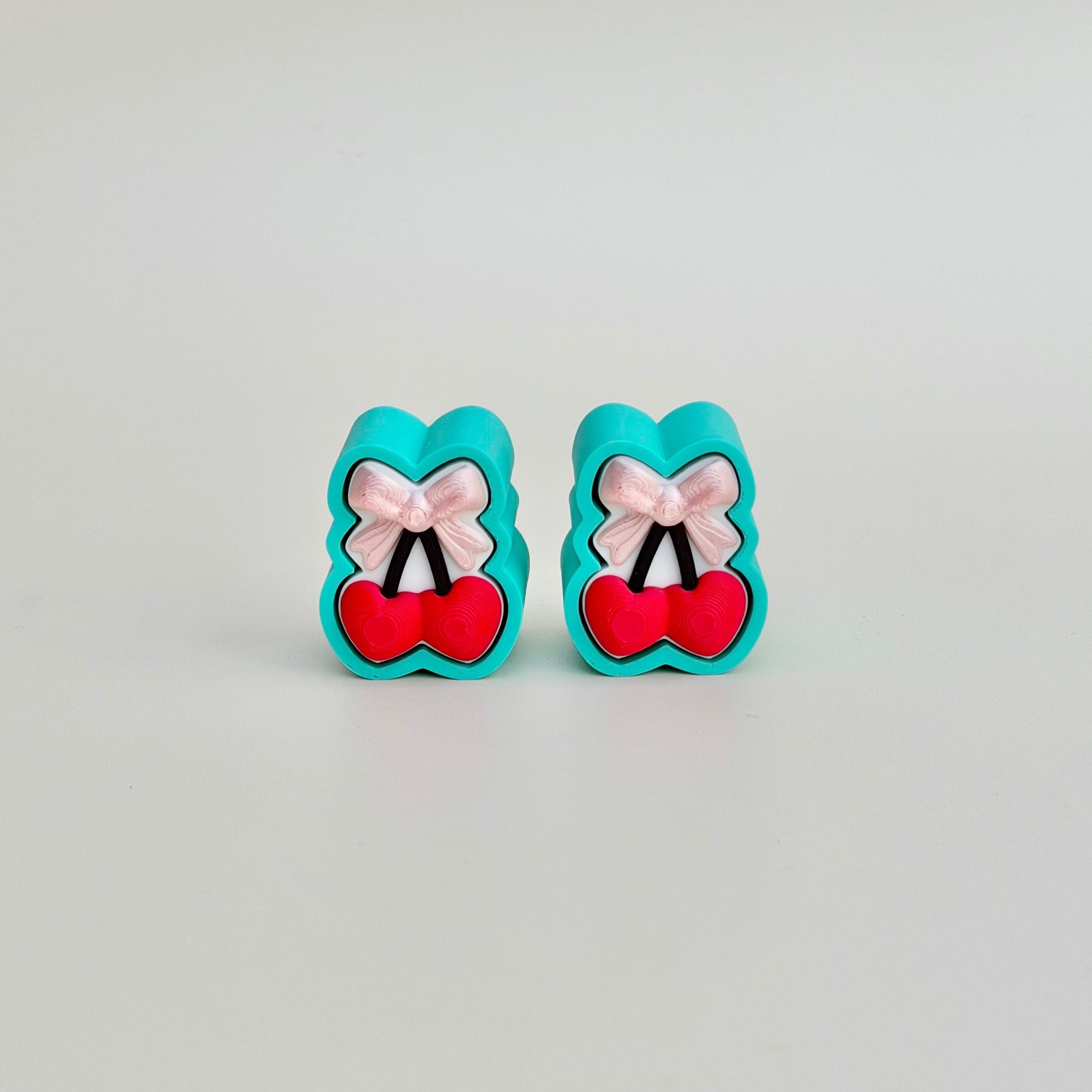 Small clicker fidget toy with heart-cherries styling, ideal for on-the-go sensory support and everyday regulation.
