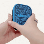 Compact fidget tin with three separate clickers inside, designed for neurodivergent focus breaks and hand regulation.
