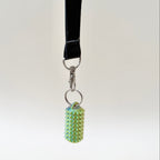 Portable spiky stim tool for tactile feedback and grounding moments, made to clip onto lanyards, bags or coats.
