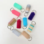 Small spiked sensory tool with keyring loop for on-the-go stimming, focus support and calming hand input.
