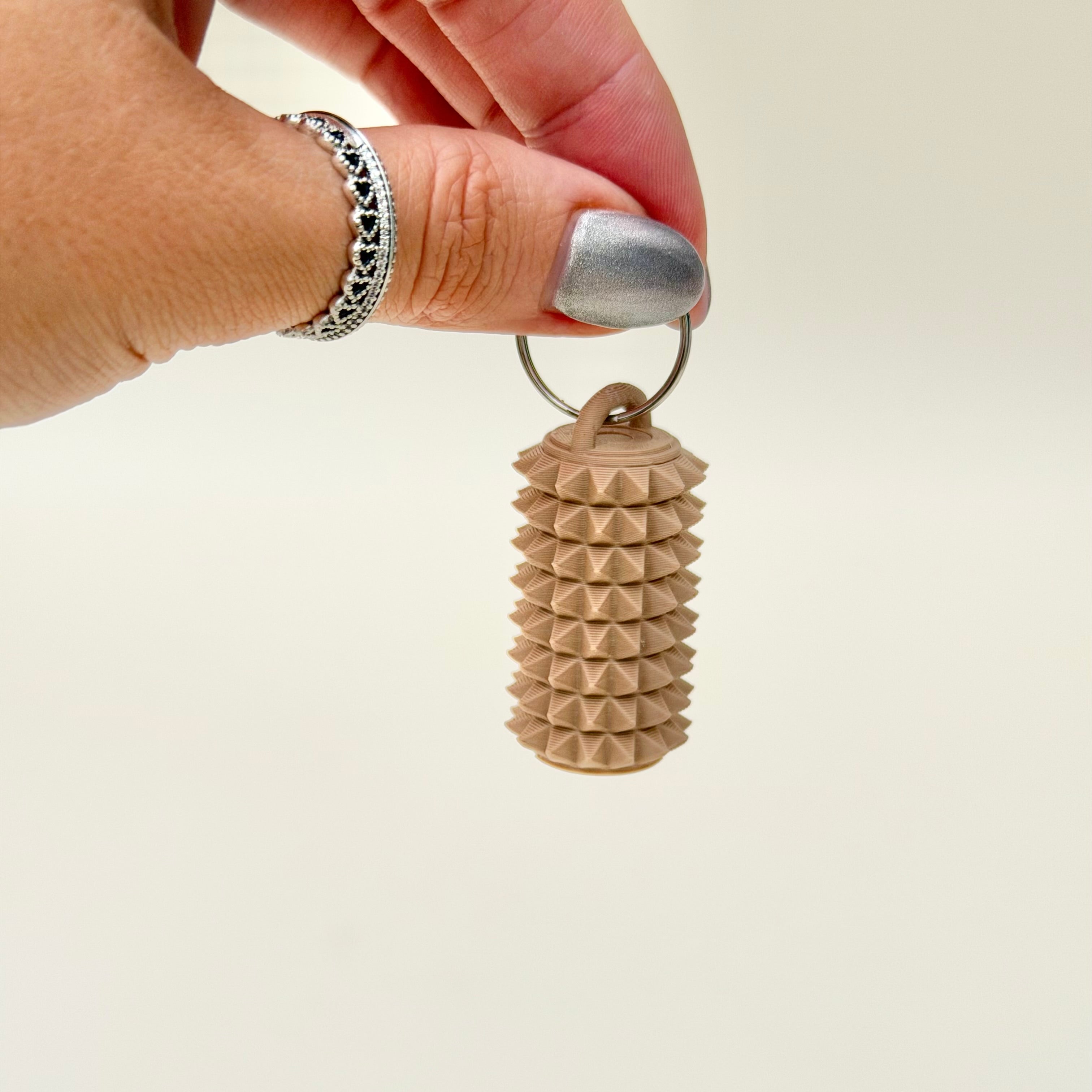 Portable spiky tactile fidget accessory for lanyards and everyday carry, made for grounding moments and busy hands.
