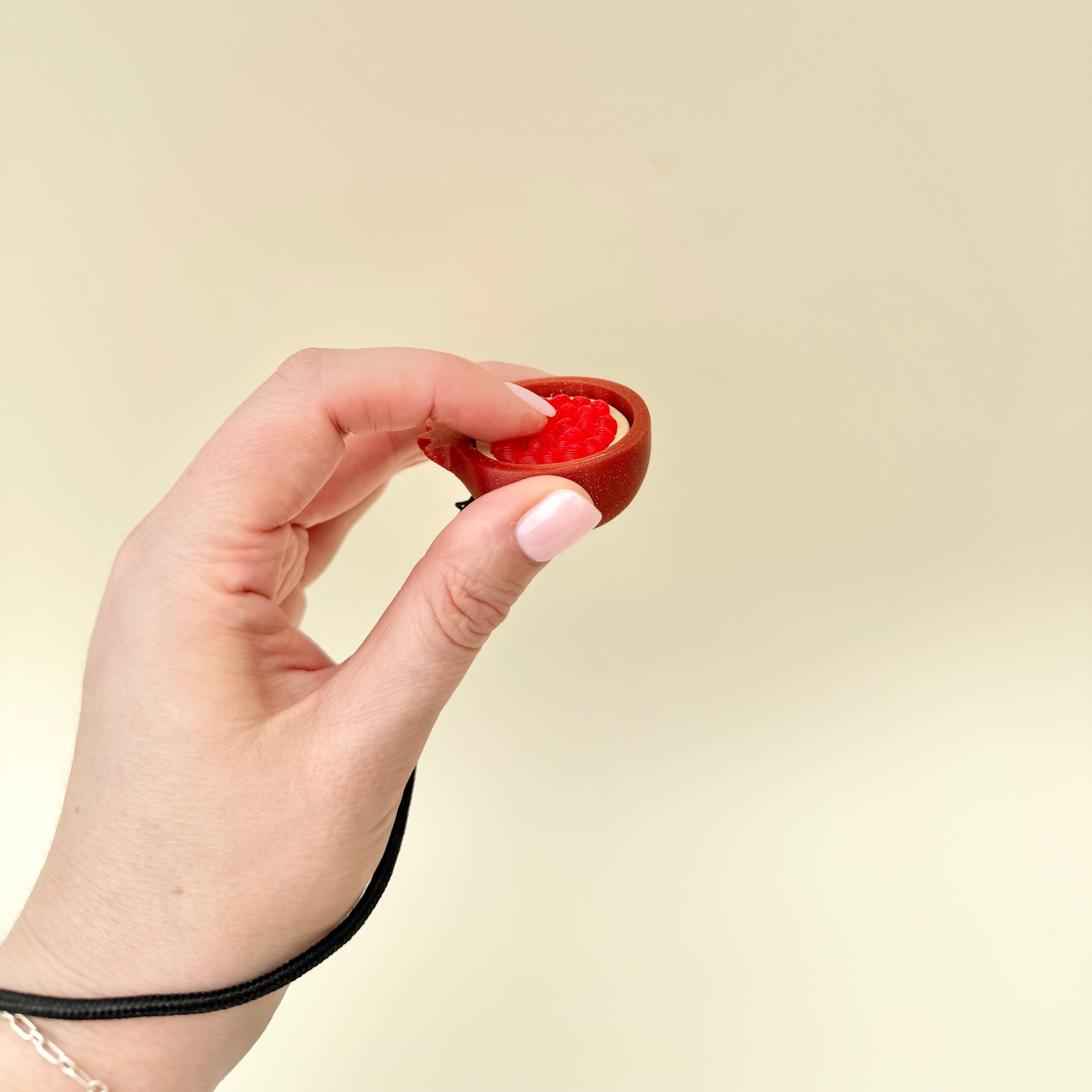 Portable sensory tool combining textured touch input with a press mechanism for calming use