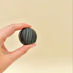 Compact handheld twist fidget with corkscrew movement designed for sensory input and focus support.
