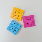 Flexible pop and press sensory fidget with push-through buttons for repetitive stimming and focus.