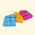 Square pop and press fidget with push-through buttons for repetitive sensory stimulation.
