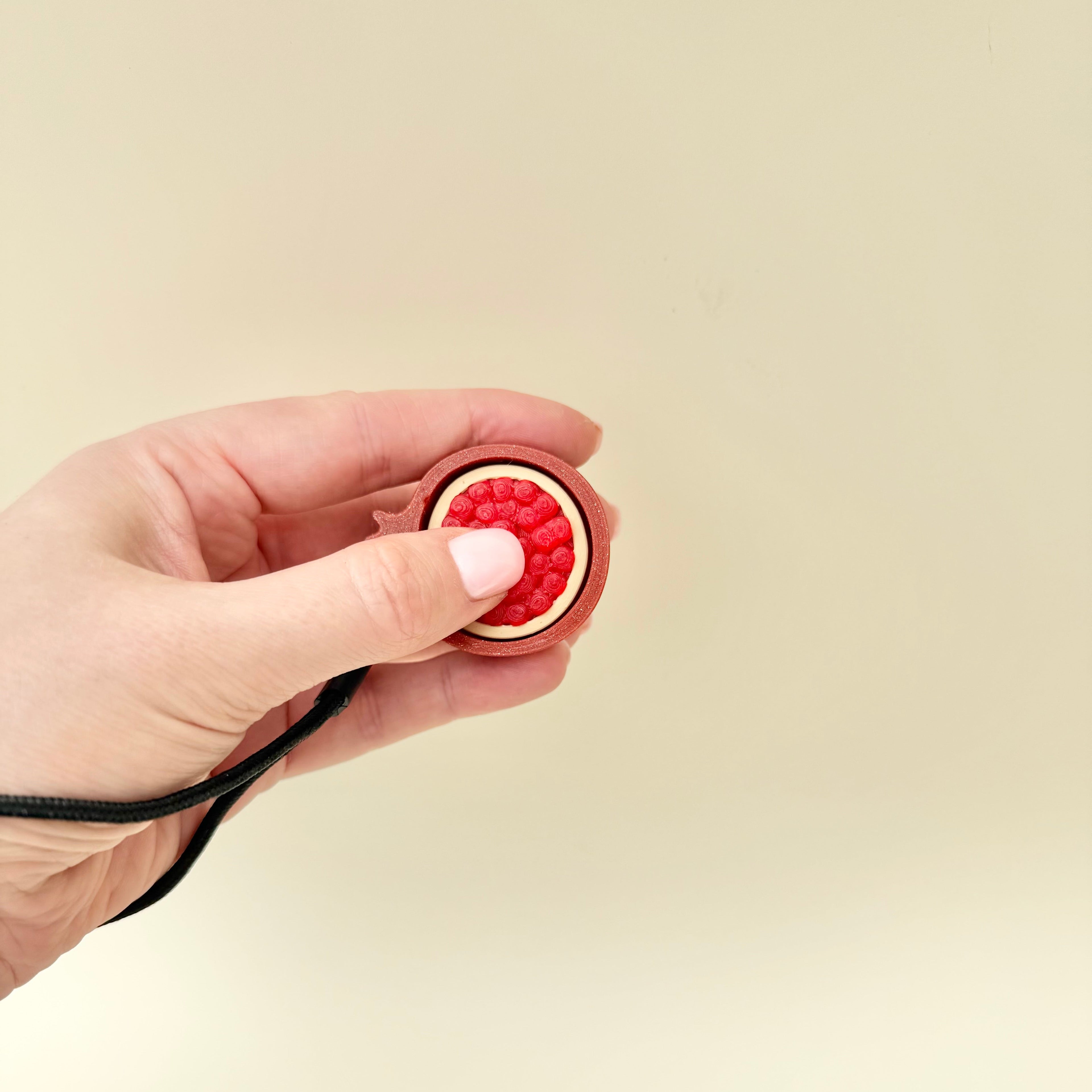 Handheld fidget for calming input, grounding and repetitive motion during travel, work or school.
