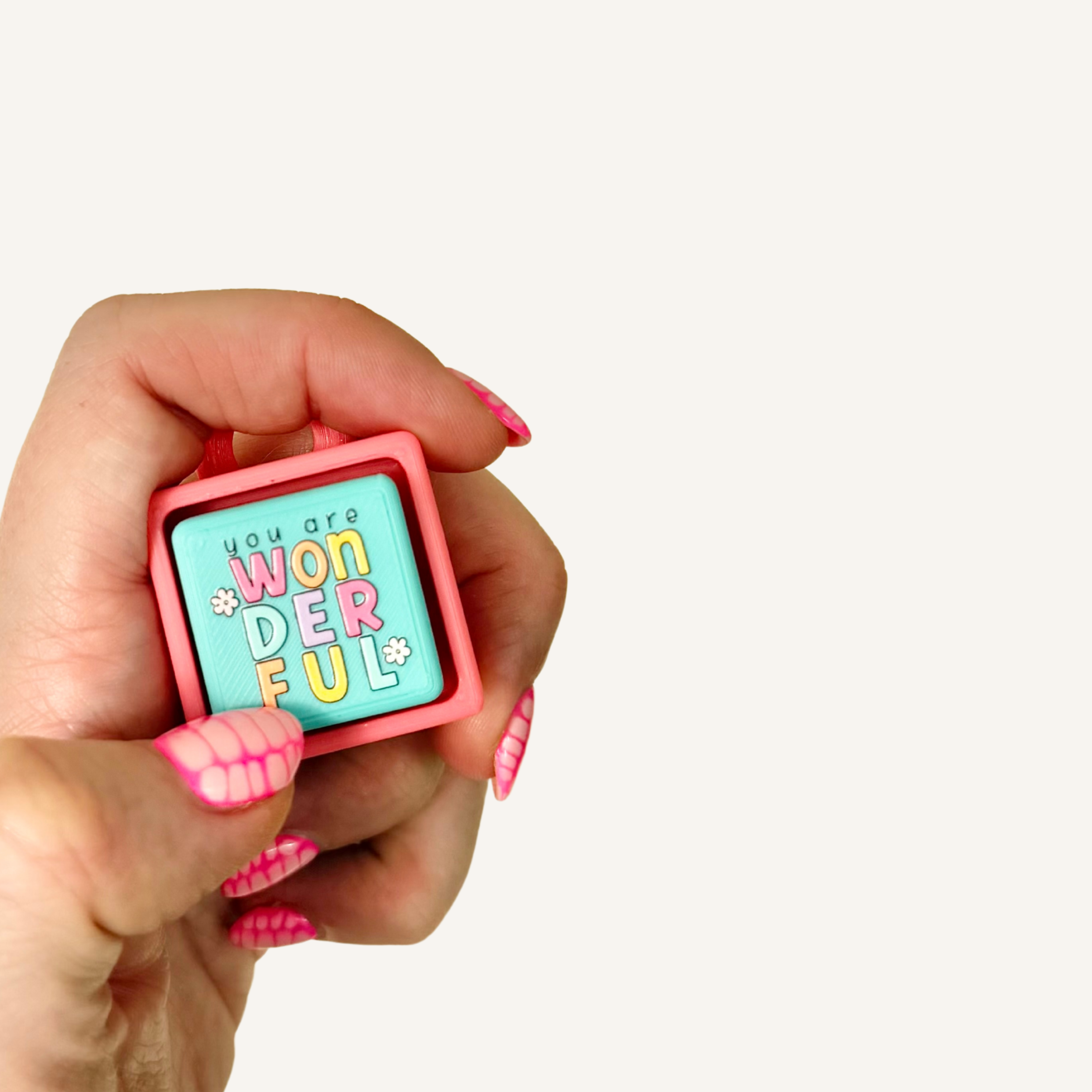 Sensory clicker with an uplifting “You’re Wonderful” message and colourful tactile front.