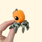 Articulated octopus with pumpkin head and metallic olive legs for quiet, tactile fidgeting.

