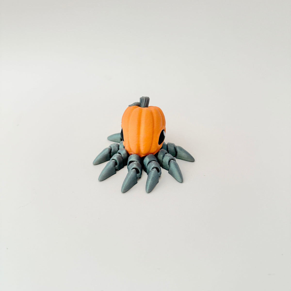 Realistic-style pumpkin octopus designed for smooth, bendy motion on a desk.
