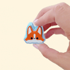 assorted dog-breed fidget clickers on a neutral background
