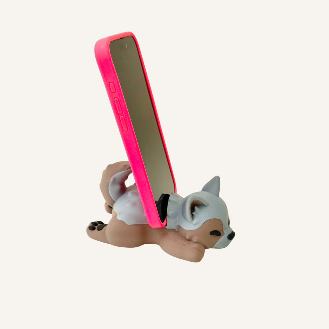 Solid puppy phone holder for keeping a phone upright on desks, study spaces or bedside tables.