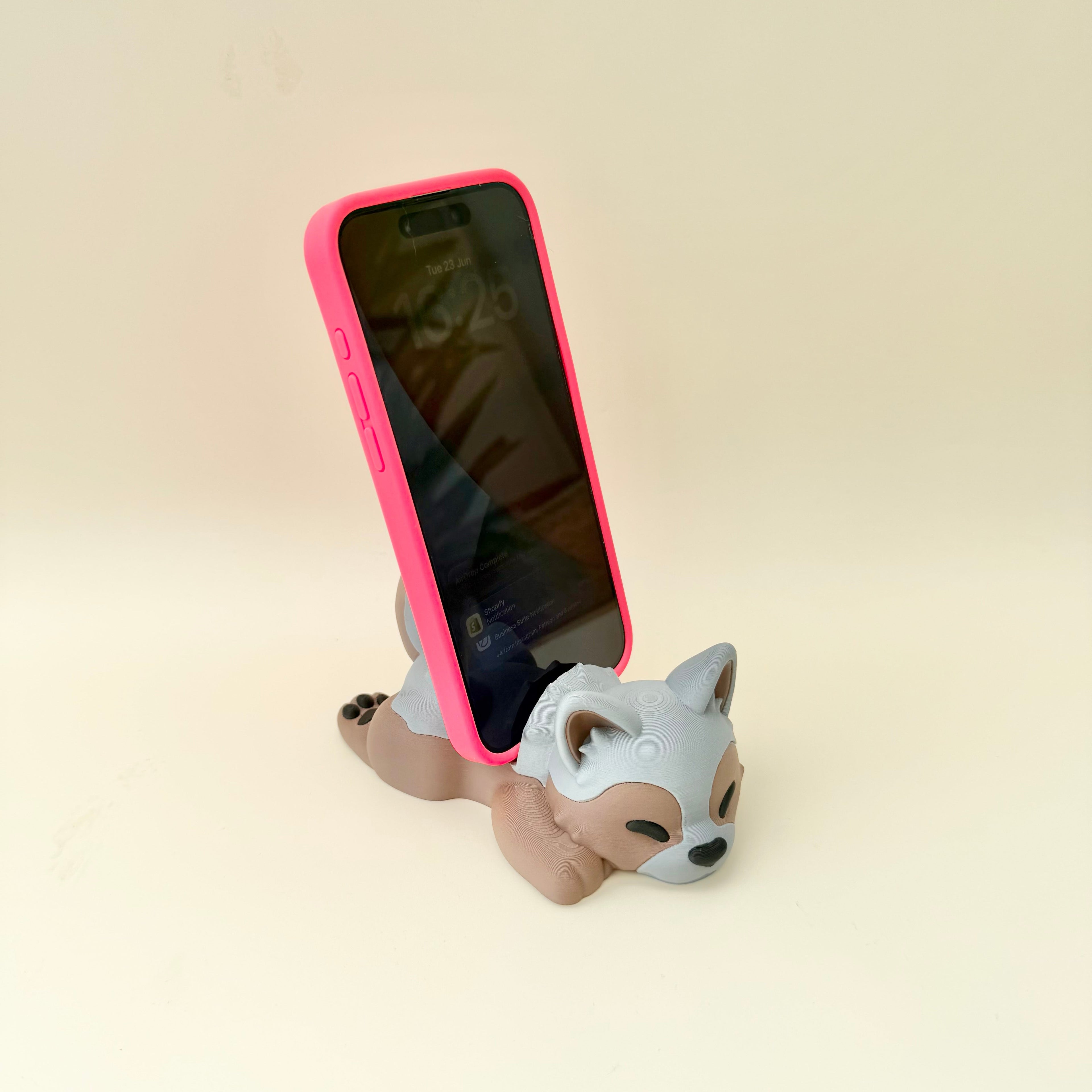 Solid decorative puppy phone rest for holding phones upright while watching, charging or working.