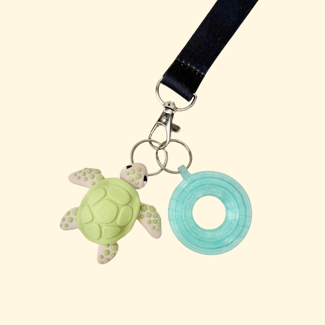Small sensory lanyard charm with moving fins and detailed shell texture for calm hands and focus.
