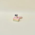 Book-themed clicker fidget with articulated tail and subtle colour variation, ideal for neurodivergent sensory needs.

