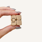 Textured fold and flip fidget cube with raised dot grip, compact for discreet stimming and focus.
