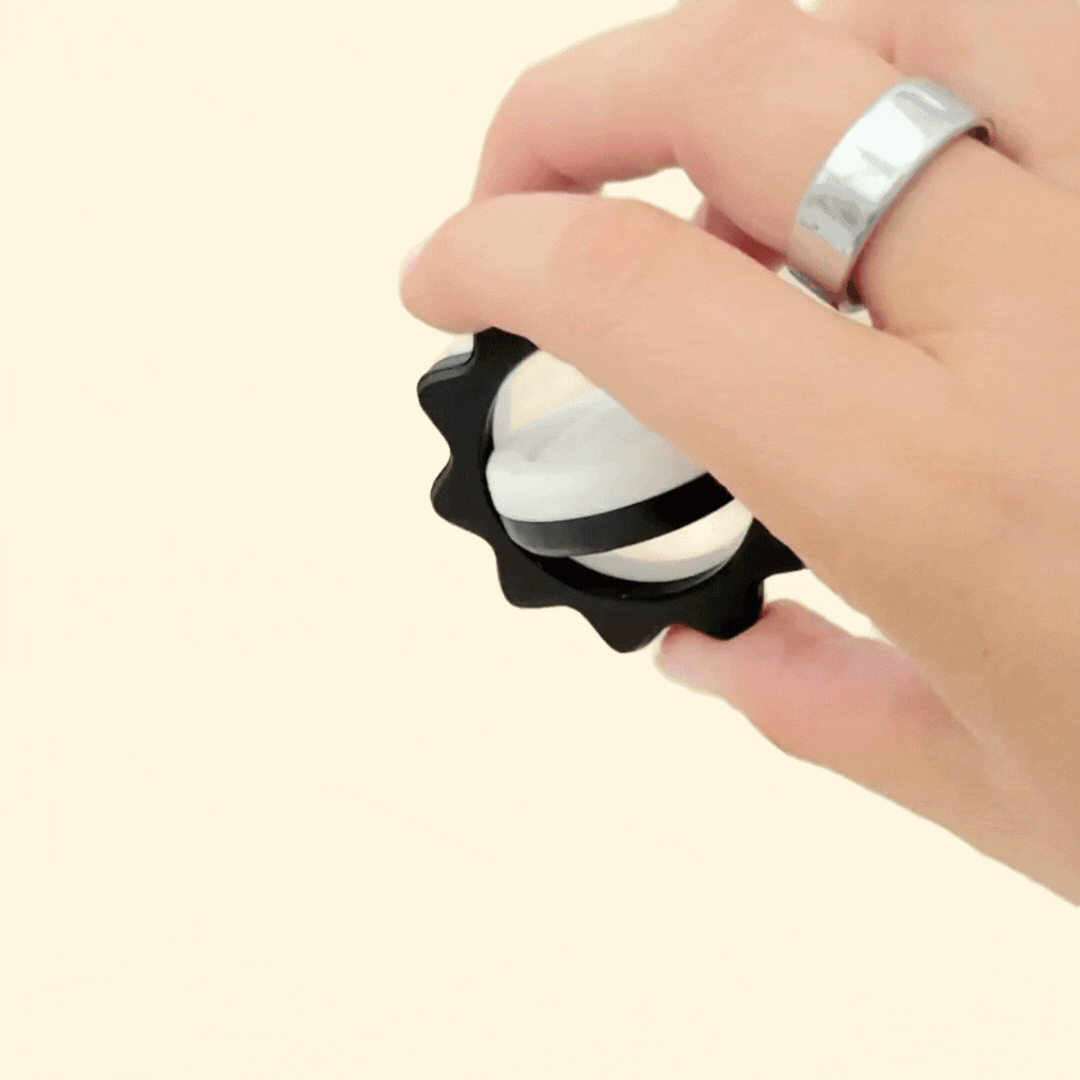 textured wavy outer rim for tactile tracing and secure grip on a nested-ring spinner
