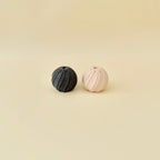 Small textured twist fidget with spiral grooves that provide tactile feedback and repetitive motion.
