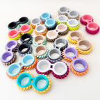 Discreet desk fidget with ridged wheels, repetitive motion and calming input for busy hands.