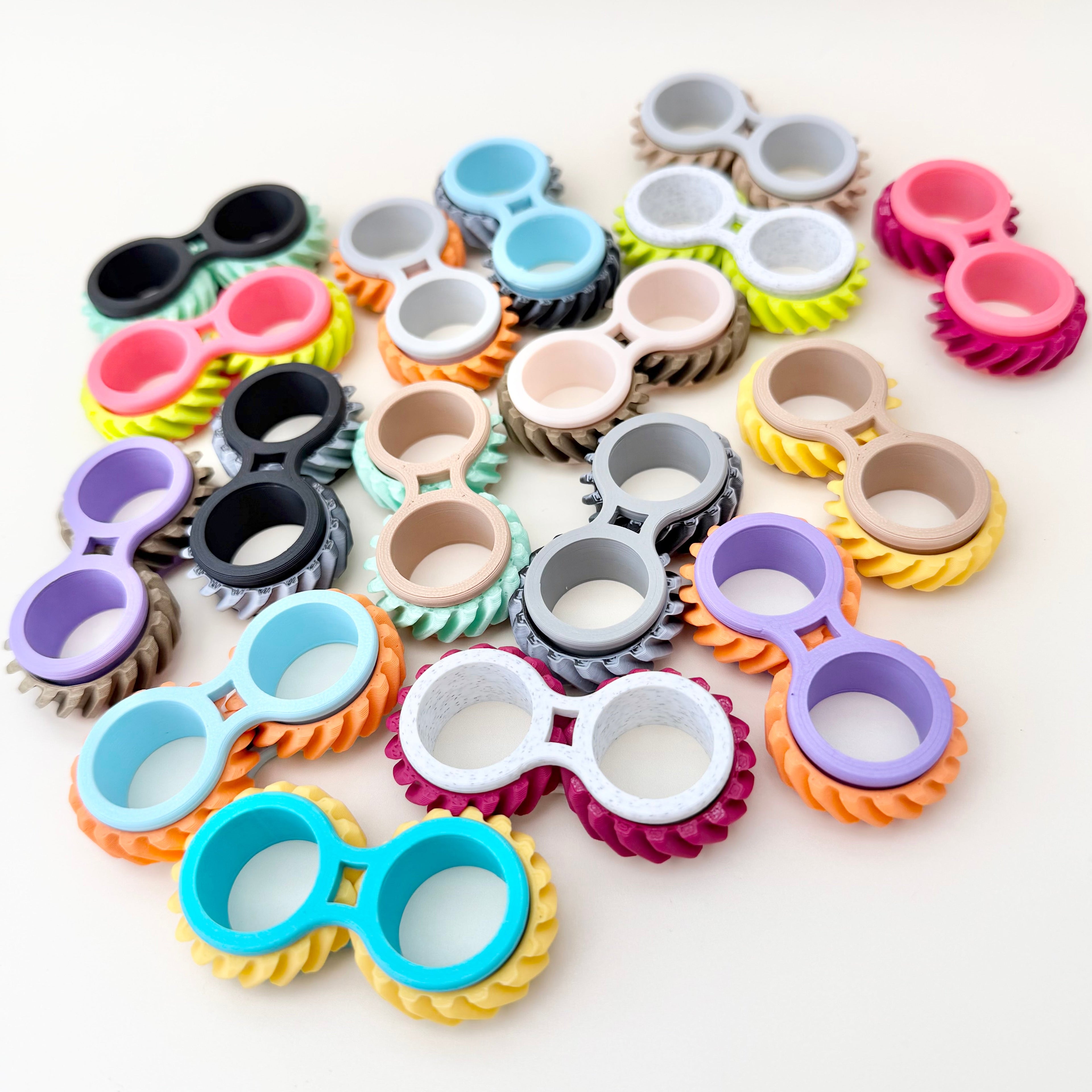 Discreet desk fidget with ridged wheels, repetitive motion and calming input for busy hands.