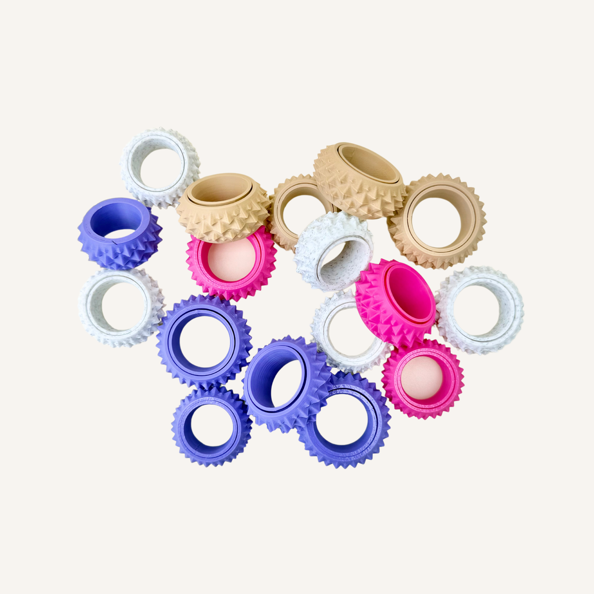 Textured sensory ring designed to rotate around the finger and roll against the skin.