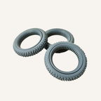 Grey sensory roller with spinning centre ring and textured outer surface for sensory input.
