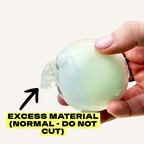 Tactile cracking experience toy that opens with visible wax cracks, giving satisfying crunch and squish play.